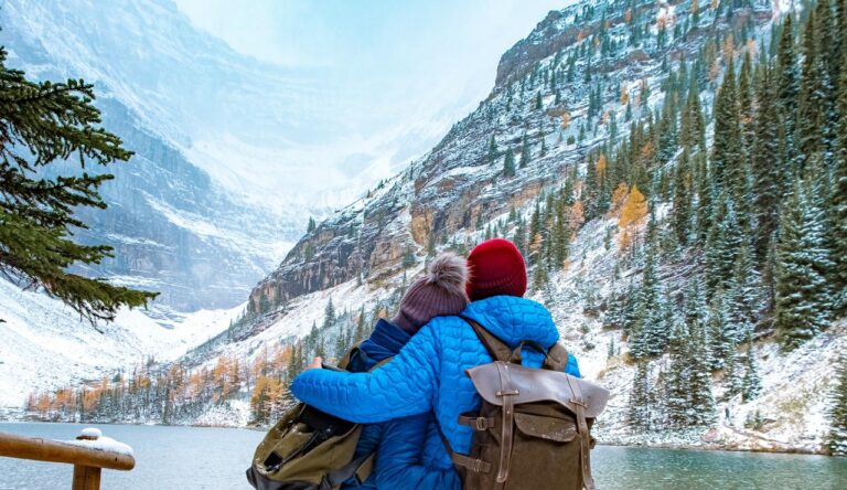 Lake Agnes Canada near Lake Louise Canada Alberta. Couple hiking in the forest with snow by Lake Louise Canada Alberta Canadian Rockies during winter.