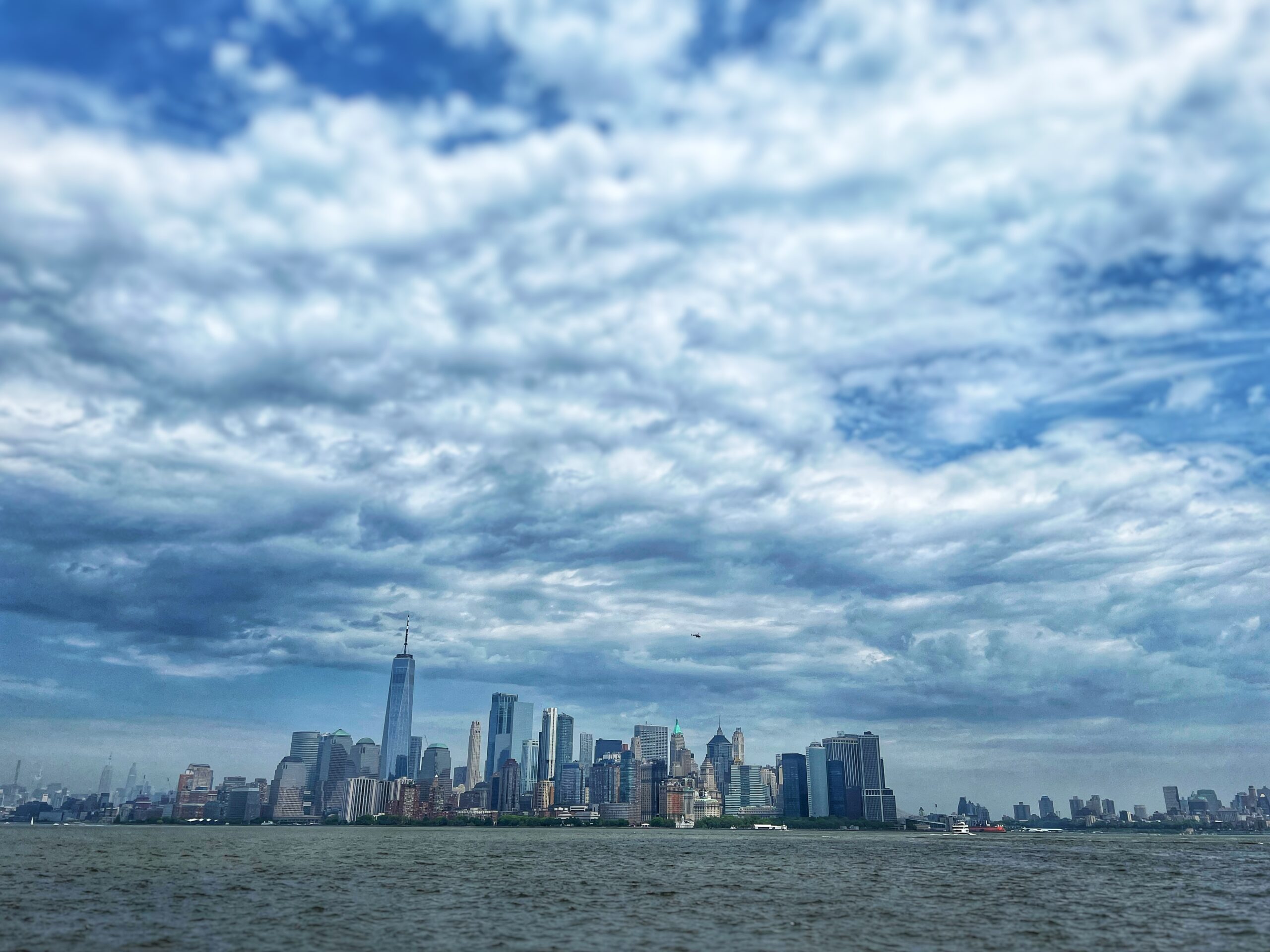 Skyline of New York City from the ferry on a cloudy day. 