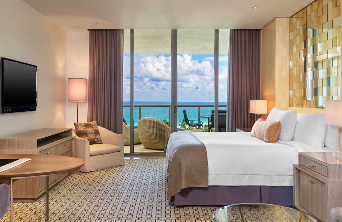 Guest room at St. Regis Hotel with big windows overlooking the ocean.