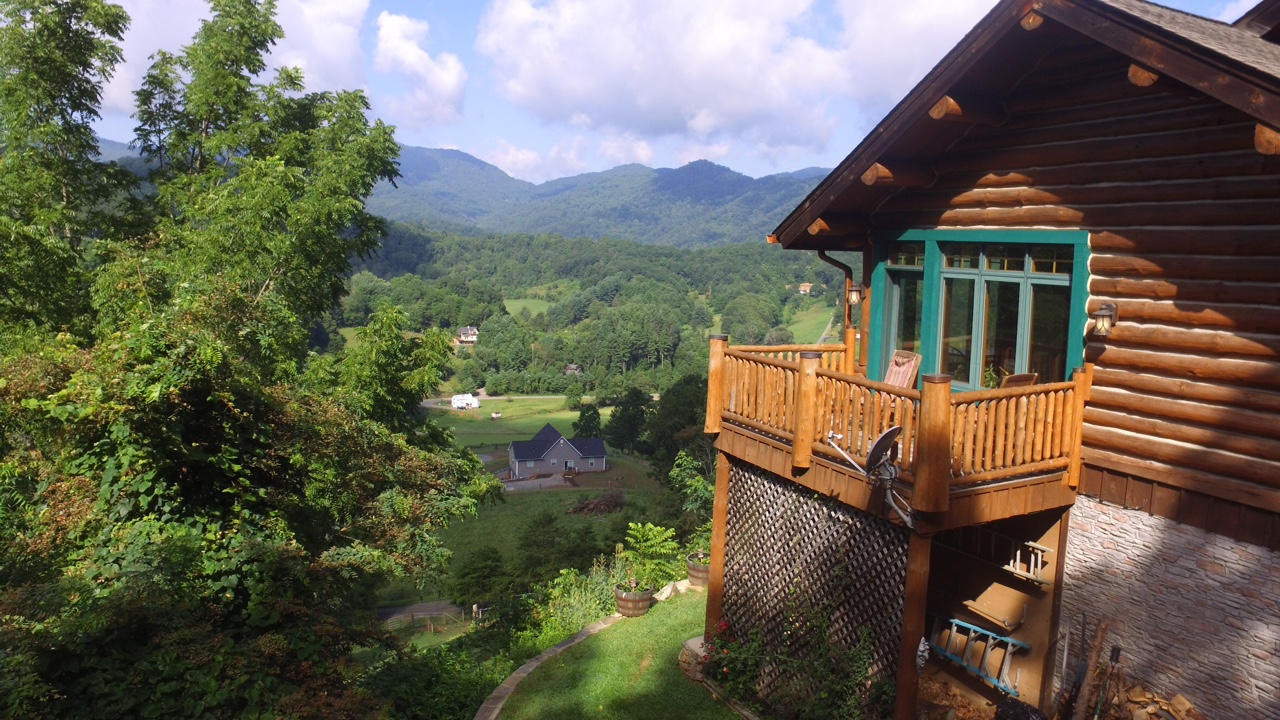 External view of honeymoon suite deck overlooking mountains.