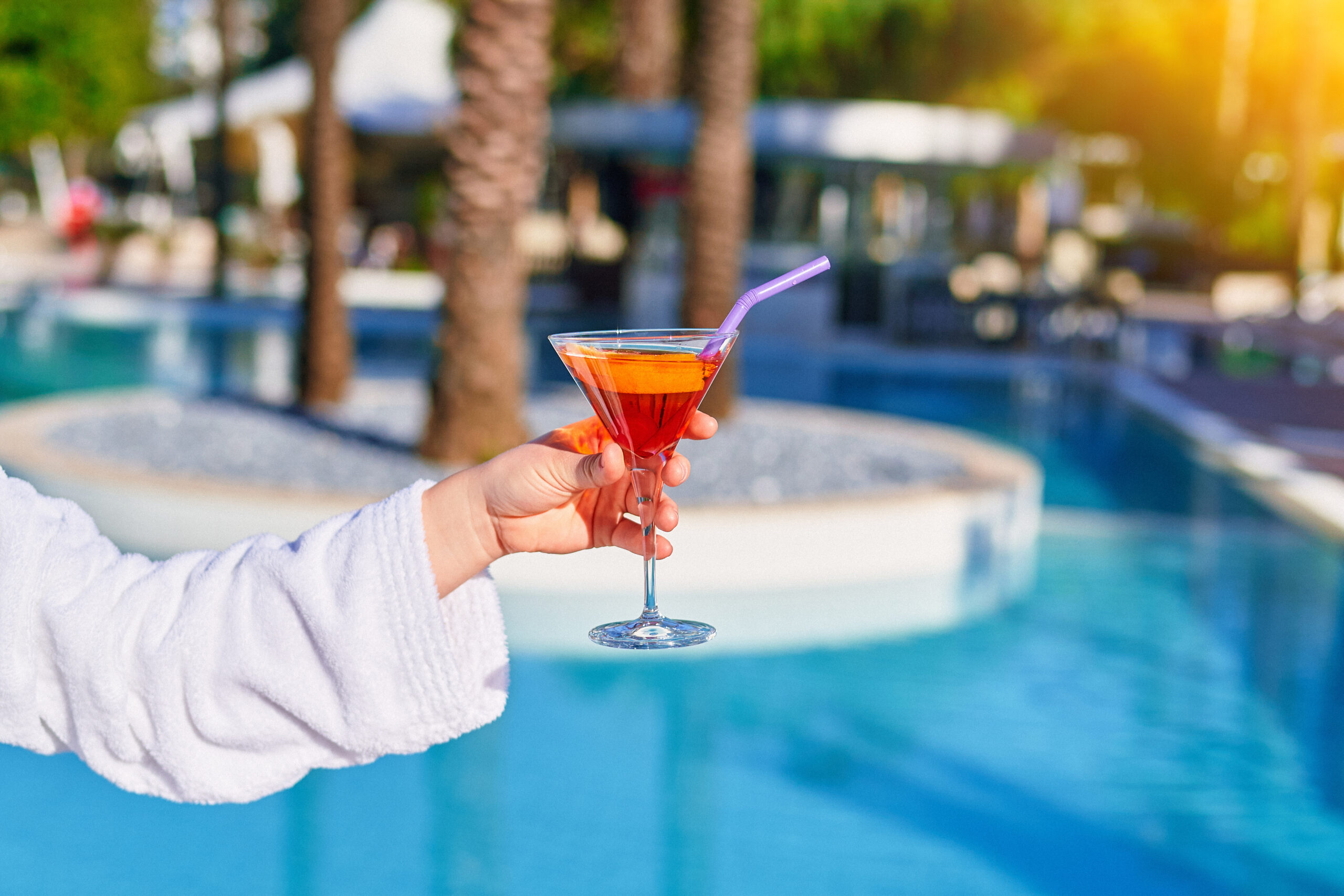 Relaxing vacations with refreshing aperol cocktail by the pool at the all-inclusive resort.