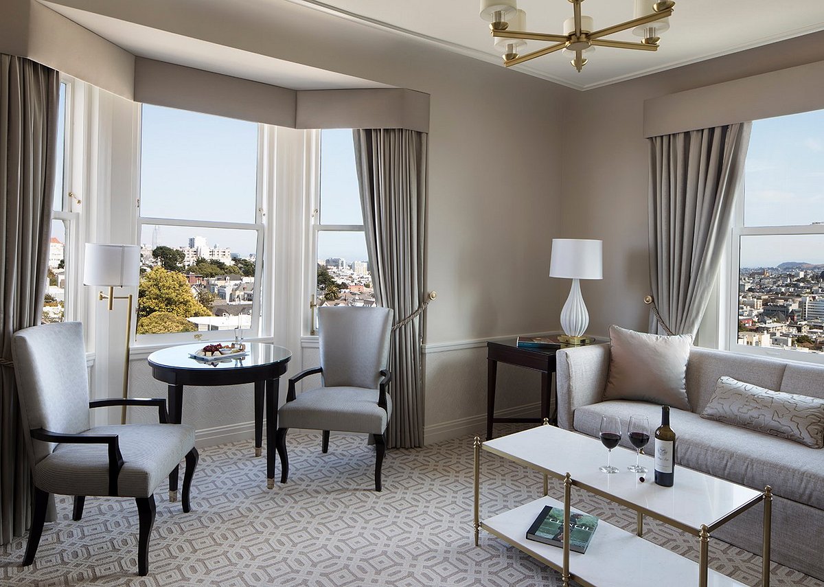 Suite at the Hotel Drisco with seating and wine glasses overlooking the city of San Francisco.