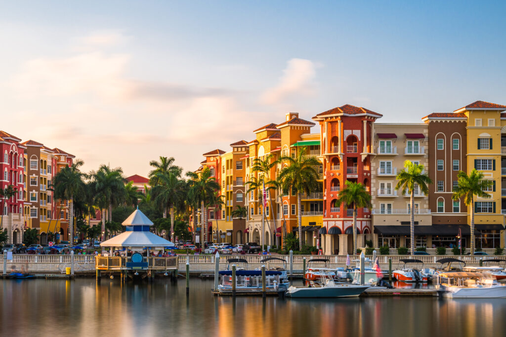Naples, Florida downtown cityscape on the bay at dusk.