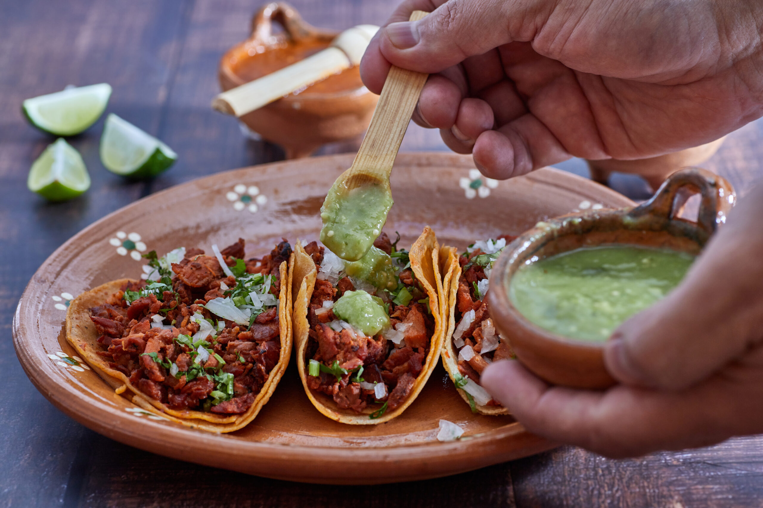 Tacos al pastor, traditional Mexican food, with onion, cilantro, pineapple, red sauce or guacamole.