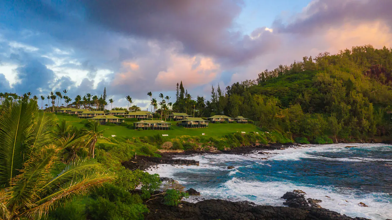 Wide view of Hana-Maui Resort along the beach at sunset.