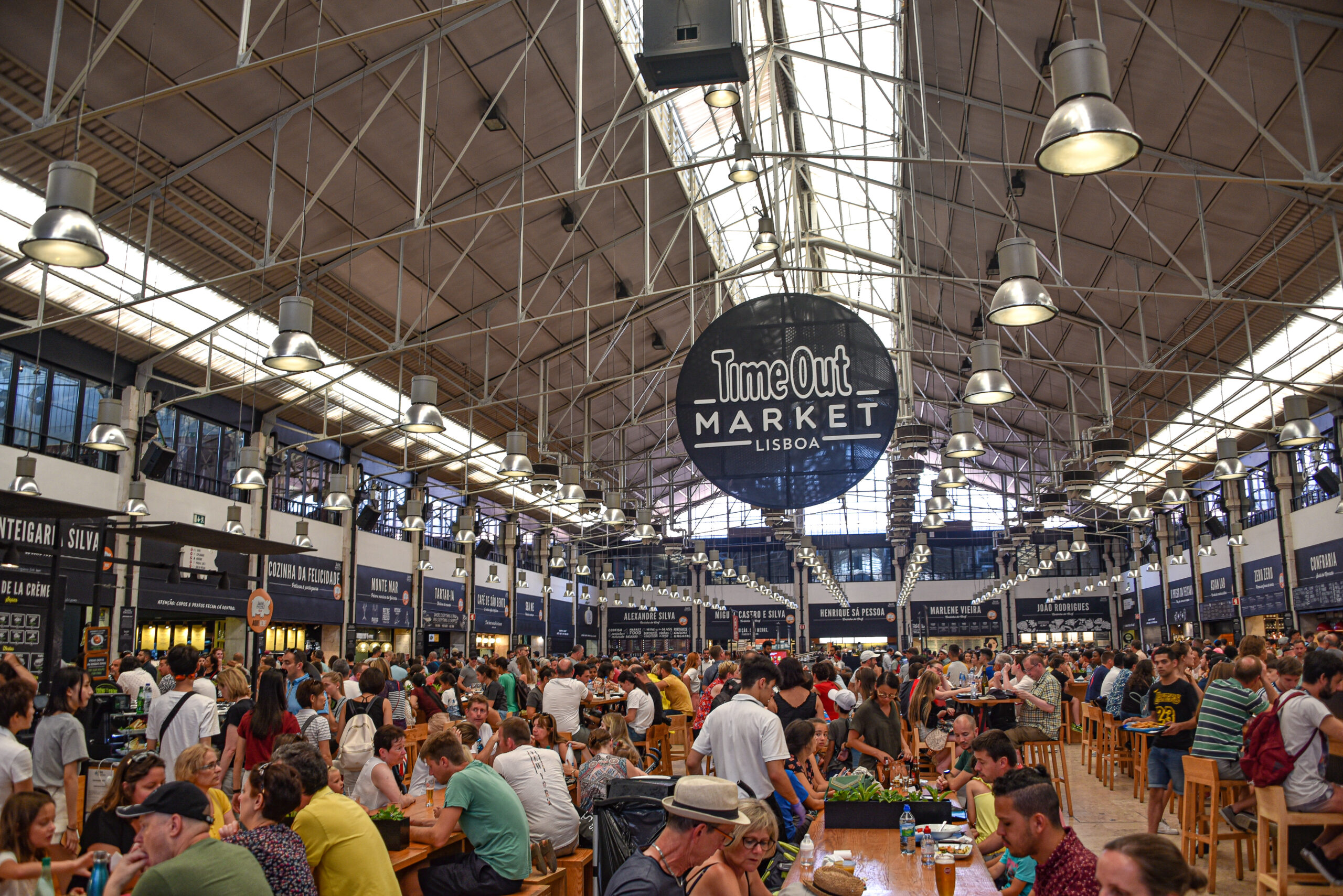 Diners at the Time Out Market, a popular foodie attraction in Lisbon. It's a must-visit on your 2 day Lisbon Itinerary!