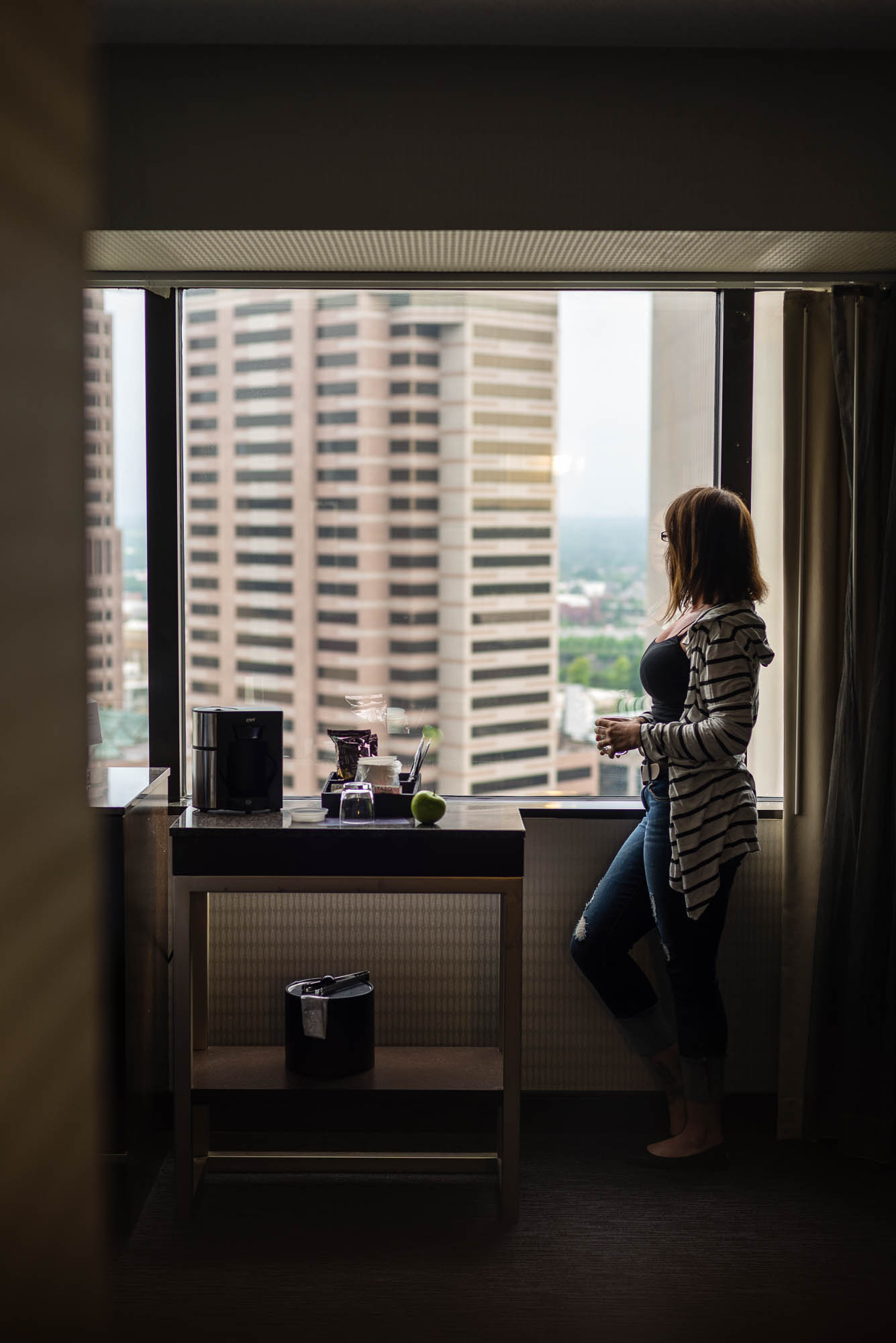 Looking out hotel window.