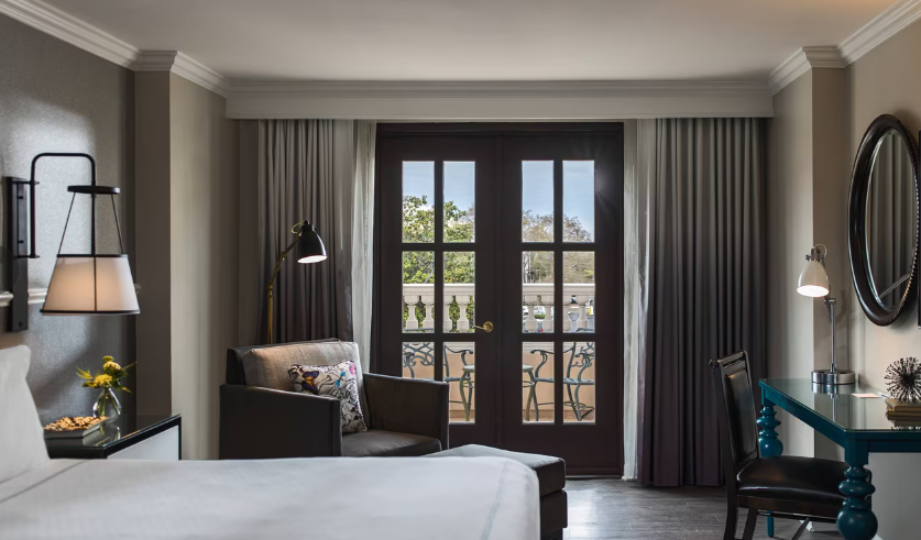 Room at The Renaissance with French doors to a scenic balcony, one of the most romantic hotels in Charleston, SC.