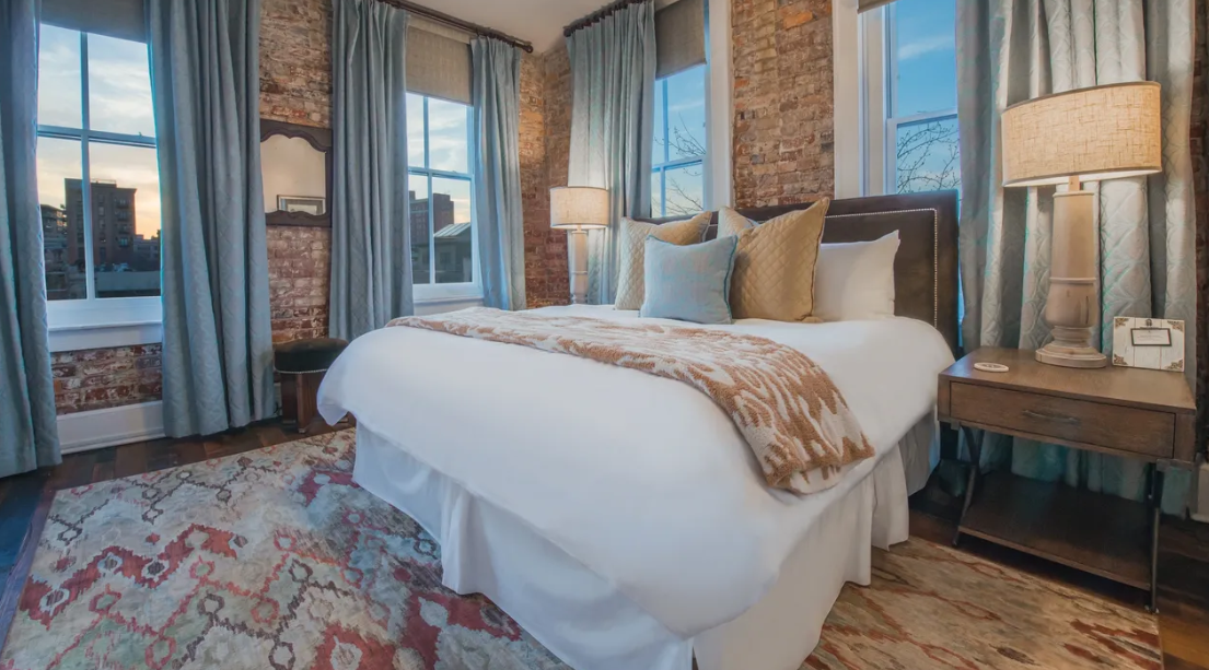 King sized bed with a view at the Windsor Boutique Hotel, one of the most romantic places to stay in Asheville NC.