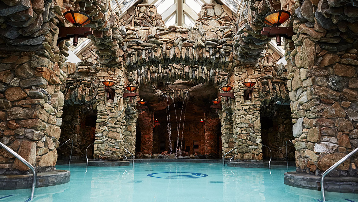 Indoor pool with stone pillars at Omni Grove Park Inn, one of the most romantic places to stay in Asheville NC.