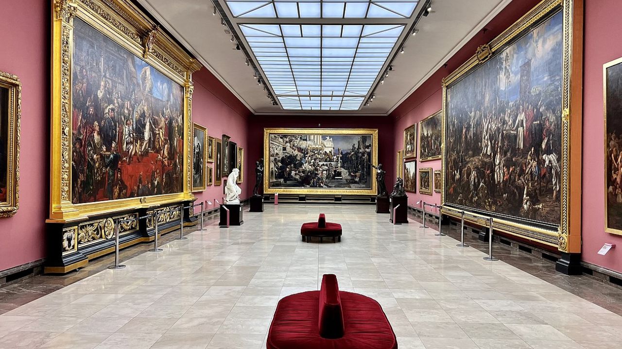 Interior view of an art gallery featuring grand paintings and sculptures, ideal for an inspiring date