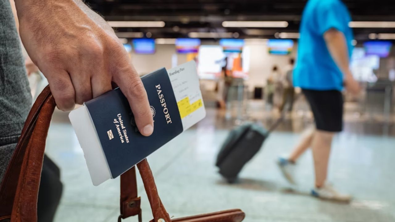 Traveler holding a passport and boarding pass at an airport terminal