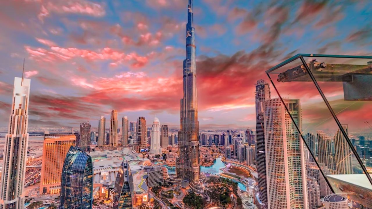 Stunning skyline of Downtown Dubai at sunset, featuring the iconic Burj Khalifa surrounded by modern skyscrapers and colorful clouds.