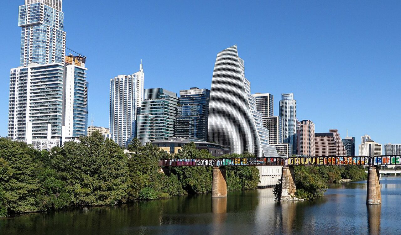 Downtown Austin skyline with the iconic graffiti bridge, home to Texas-style BBQ and a thriving food truck scene.