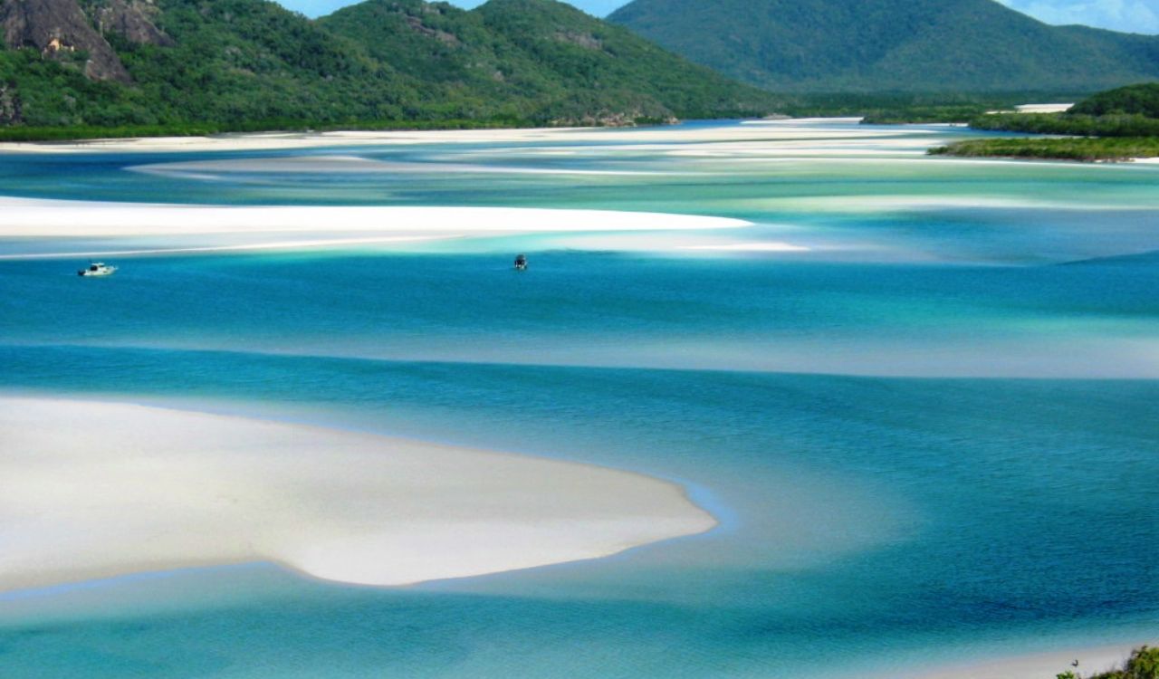 Swirls of sand in turquoise waters