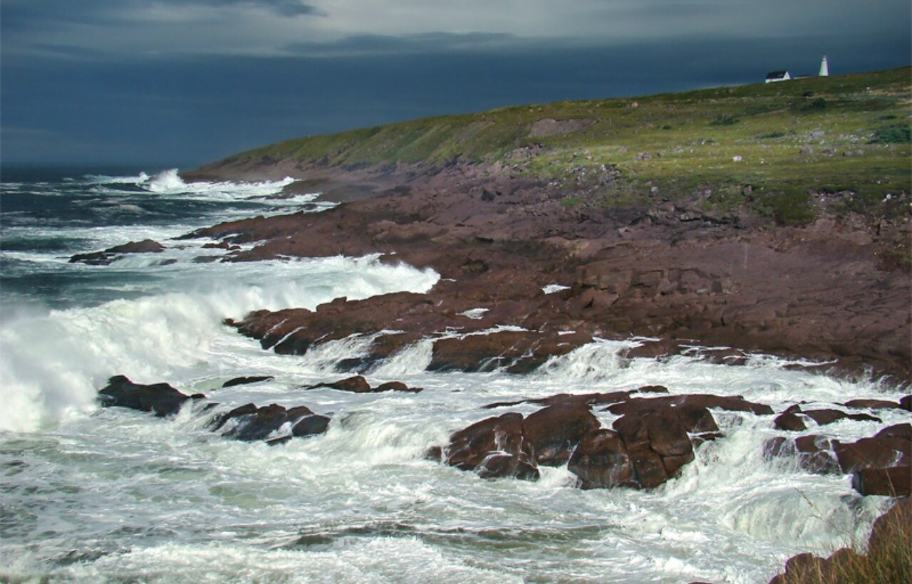 Waves crashing on rocky shore at Cape Spear, Newfoundland