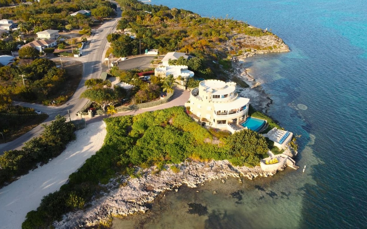 Oceanfront villa with pool on Cayman Islands coastline.