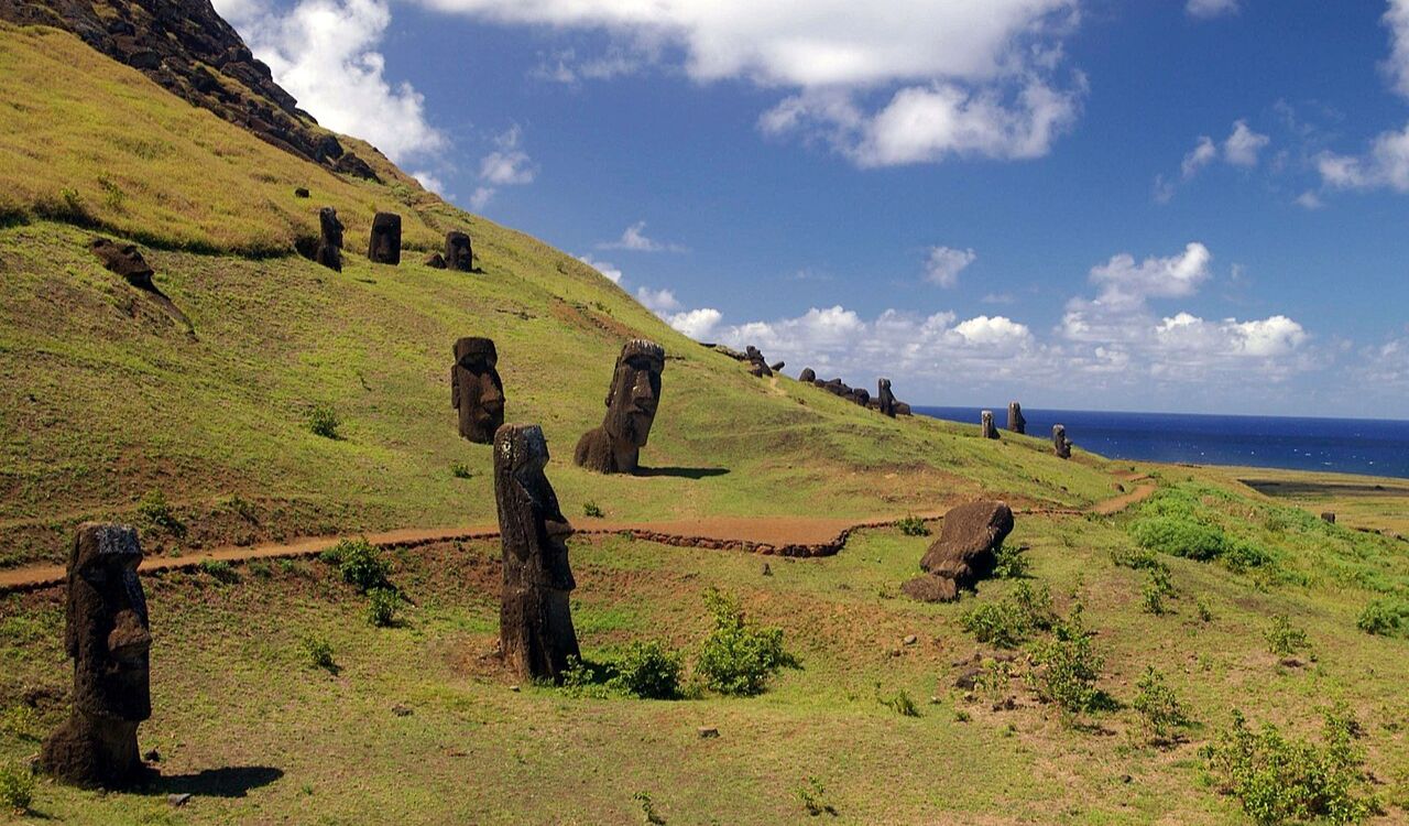 Ancient Moai statues dot the green hills of Easter Island, Chile—mysterious and iconic