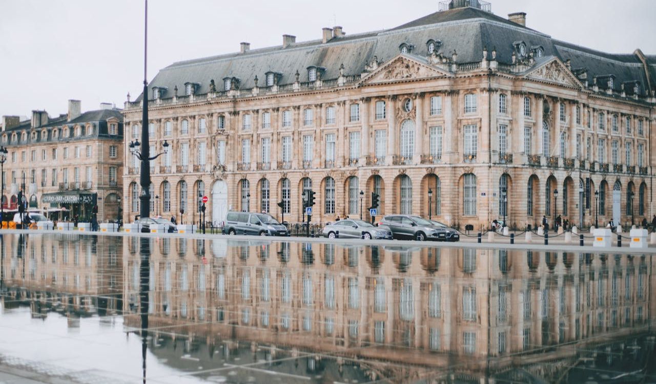 Elegant historic building reflected in water at the Palace District