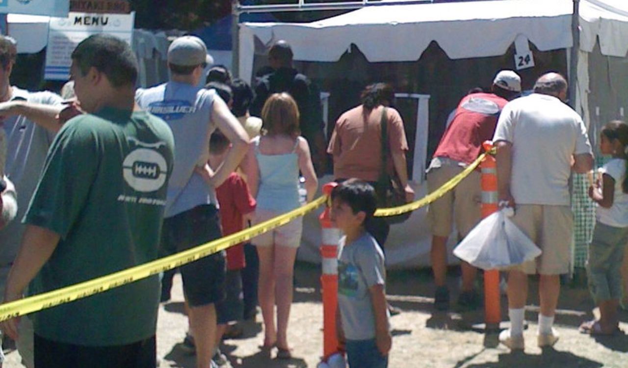 People waiting in line at a food stall during the Garlic Festival of South Australia