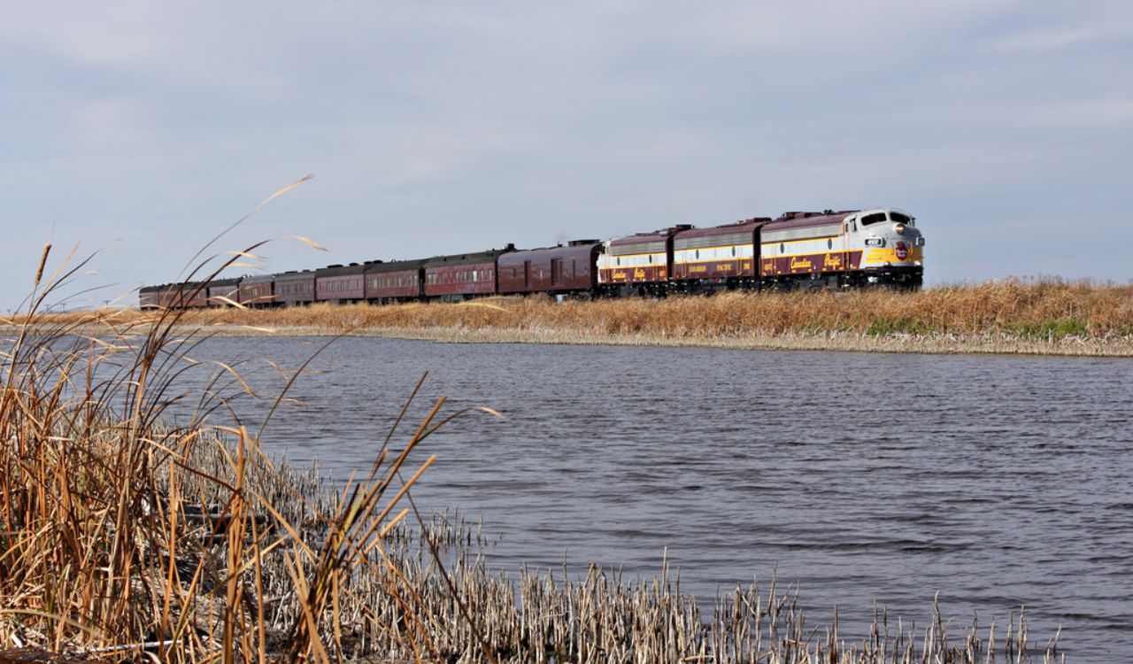 The Golden Eagle train travels along a lakeside route through Central Asia