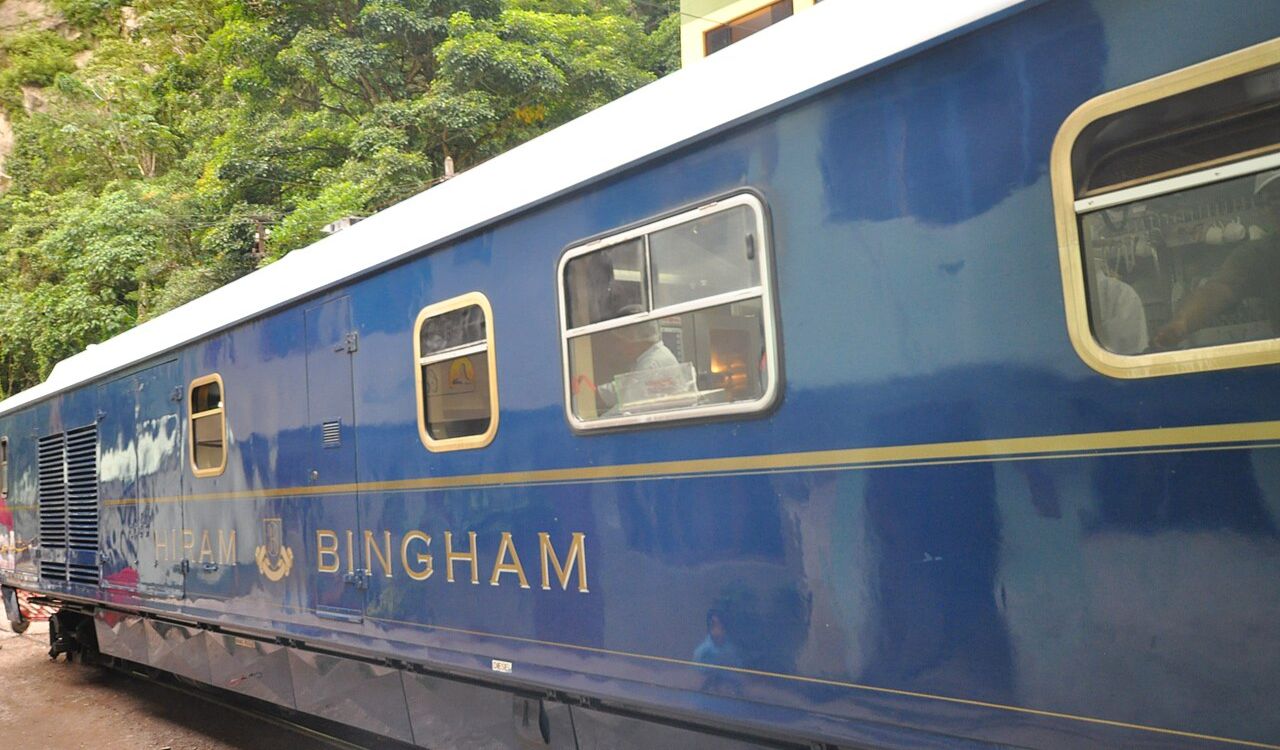 he blue and gold Hiram Bingham train in Peru at a station
