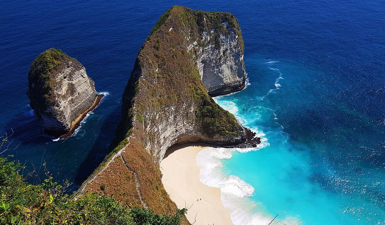 Dramatic cliffs meet serene turquoise bay