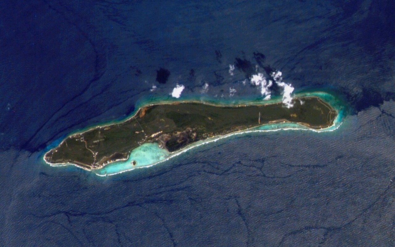 Aerial view of Little Cayman Island surrounded by blue water.