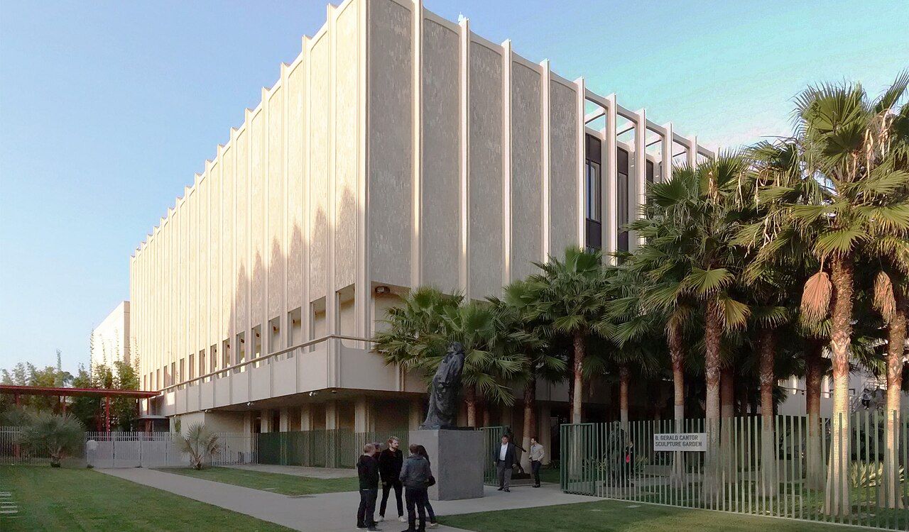 Visitors outside the Los Angeles County Museum of Art surrounded by palm trees