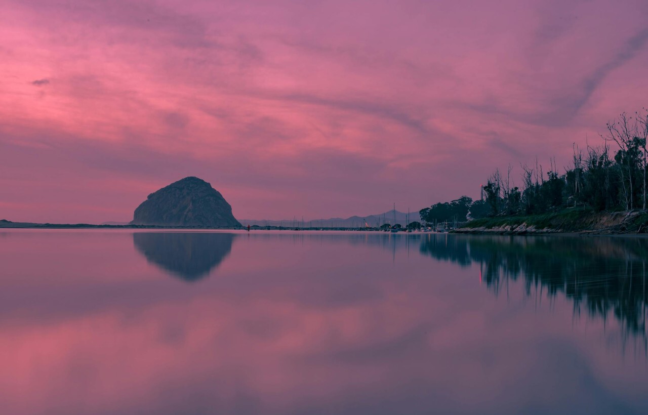 Morro Rock reflected in calm waters at sunset, Morro Bay