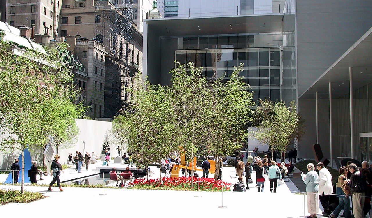 People exploring the sculpture garden at the Museum of Modern Art in New York City