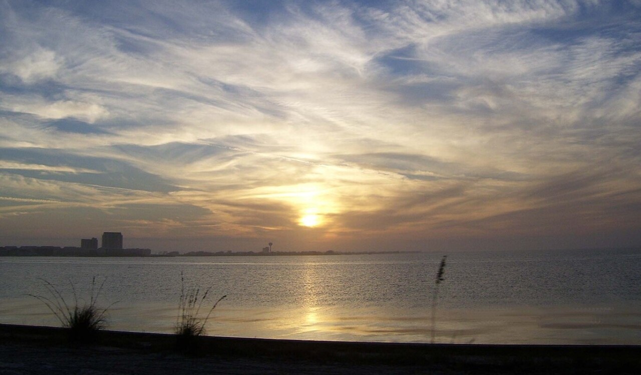 Golden sunset over calm waters at Navarre Beach, Florida