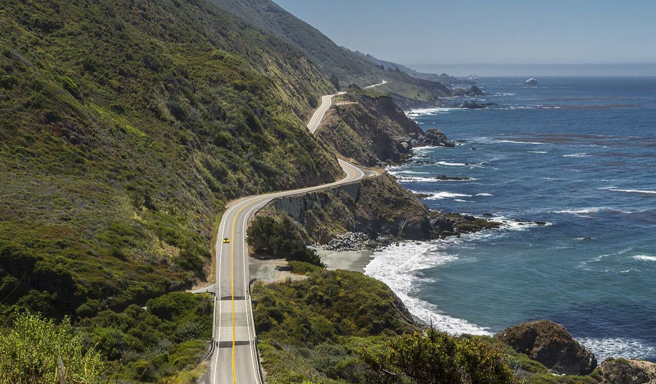 A scenic highway hugs California’s rugged coastline, offering dramatic ocean views