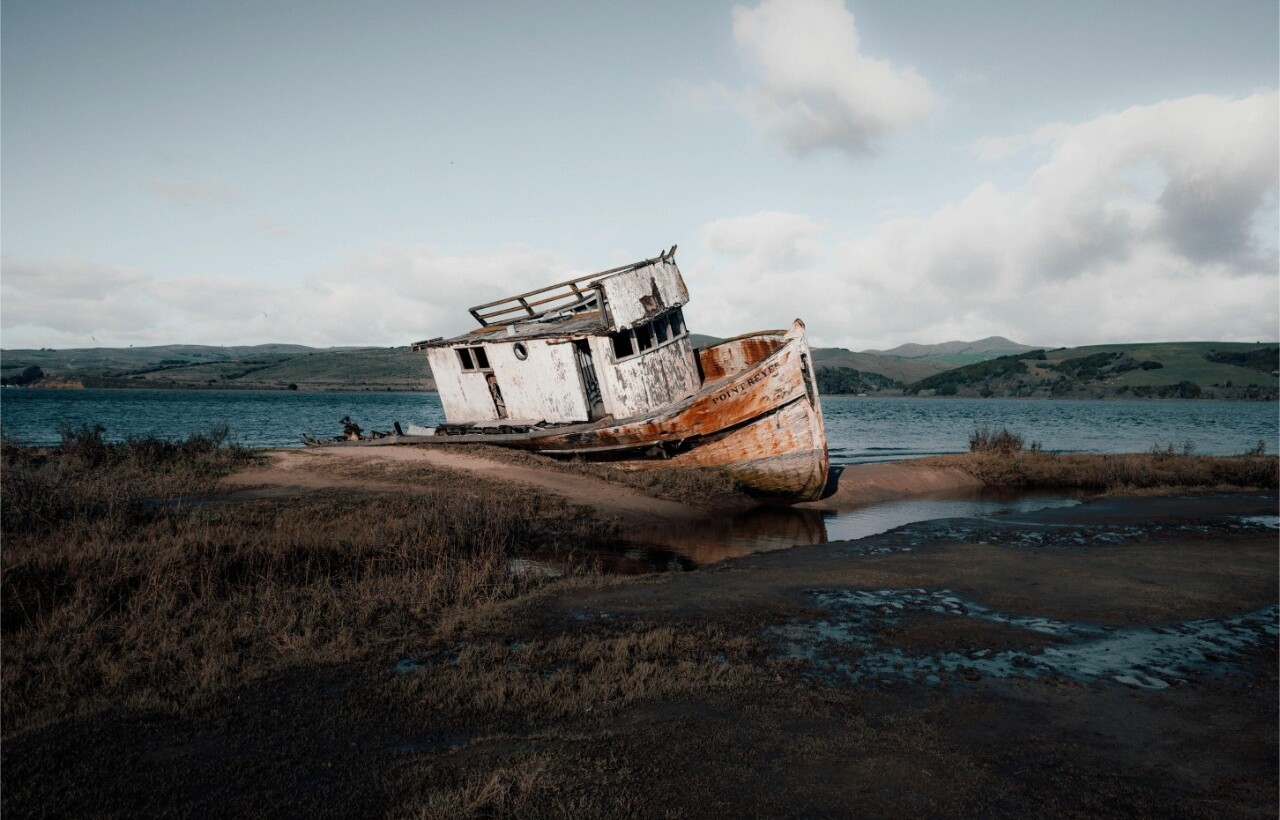 Abandoned fishing boat on shore at Point Reyes, Chimney Rock Trail
