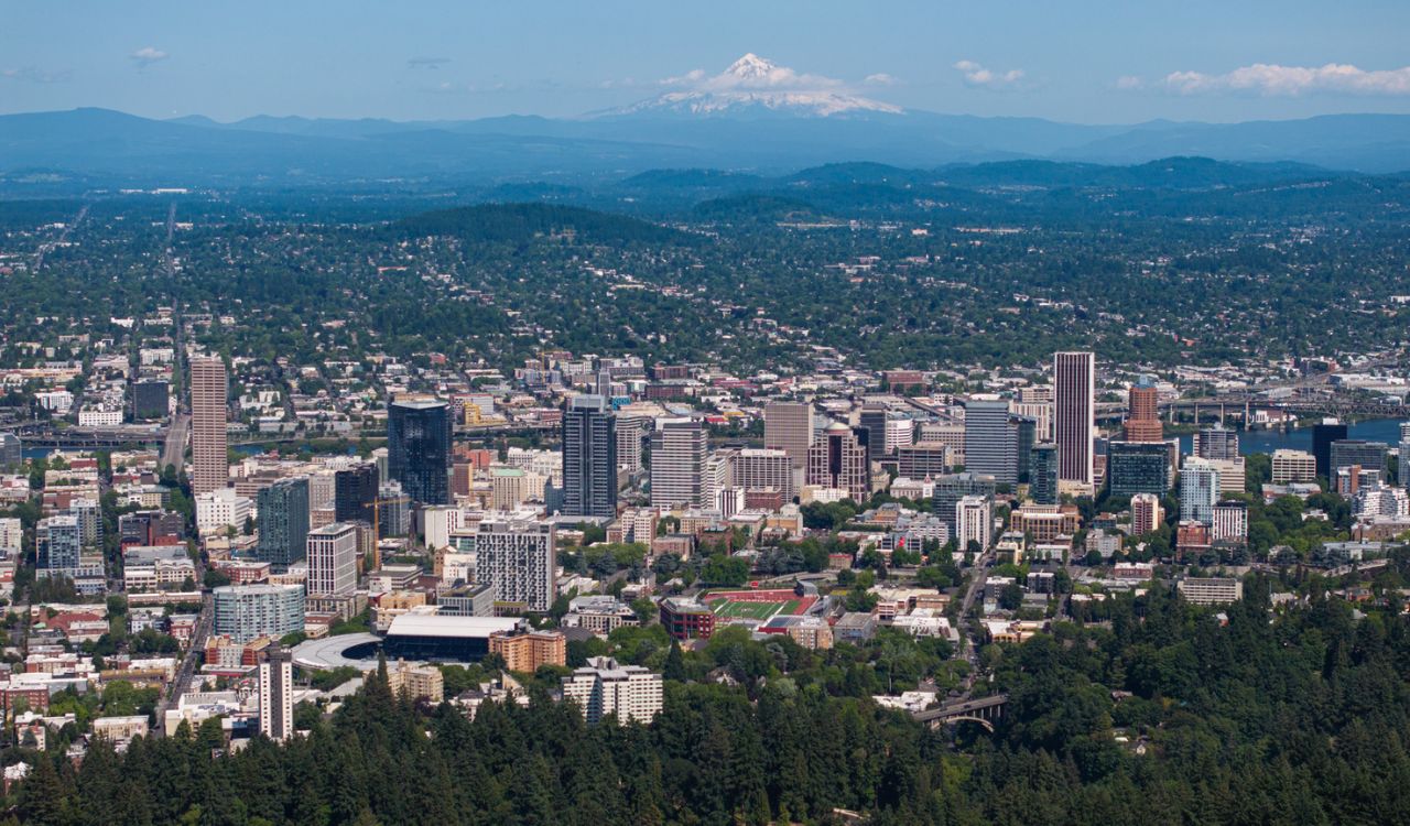 Aerial view of downtown Portland, Oregon, with Mount Hood in the background