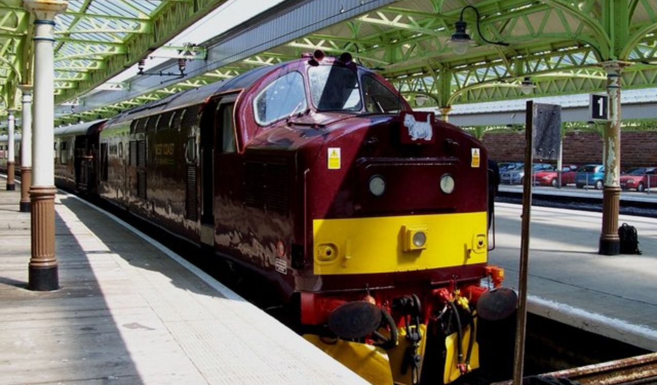 The Royal Scotsman luxury train at a station platform in Scotland