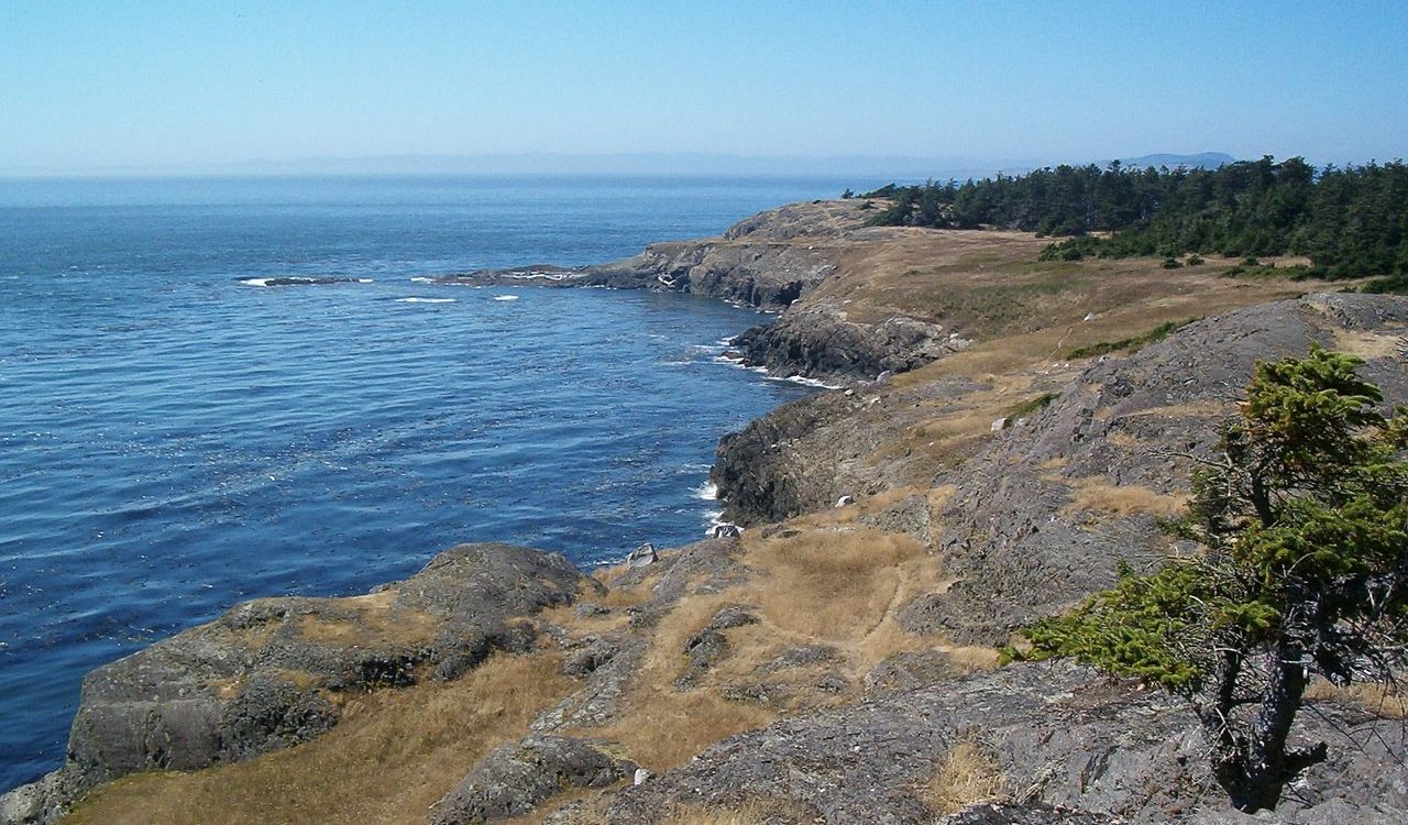 Rugged shoreline of San Juan Islands in Washington with blue ocean waters