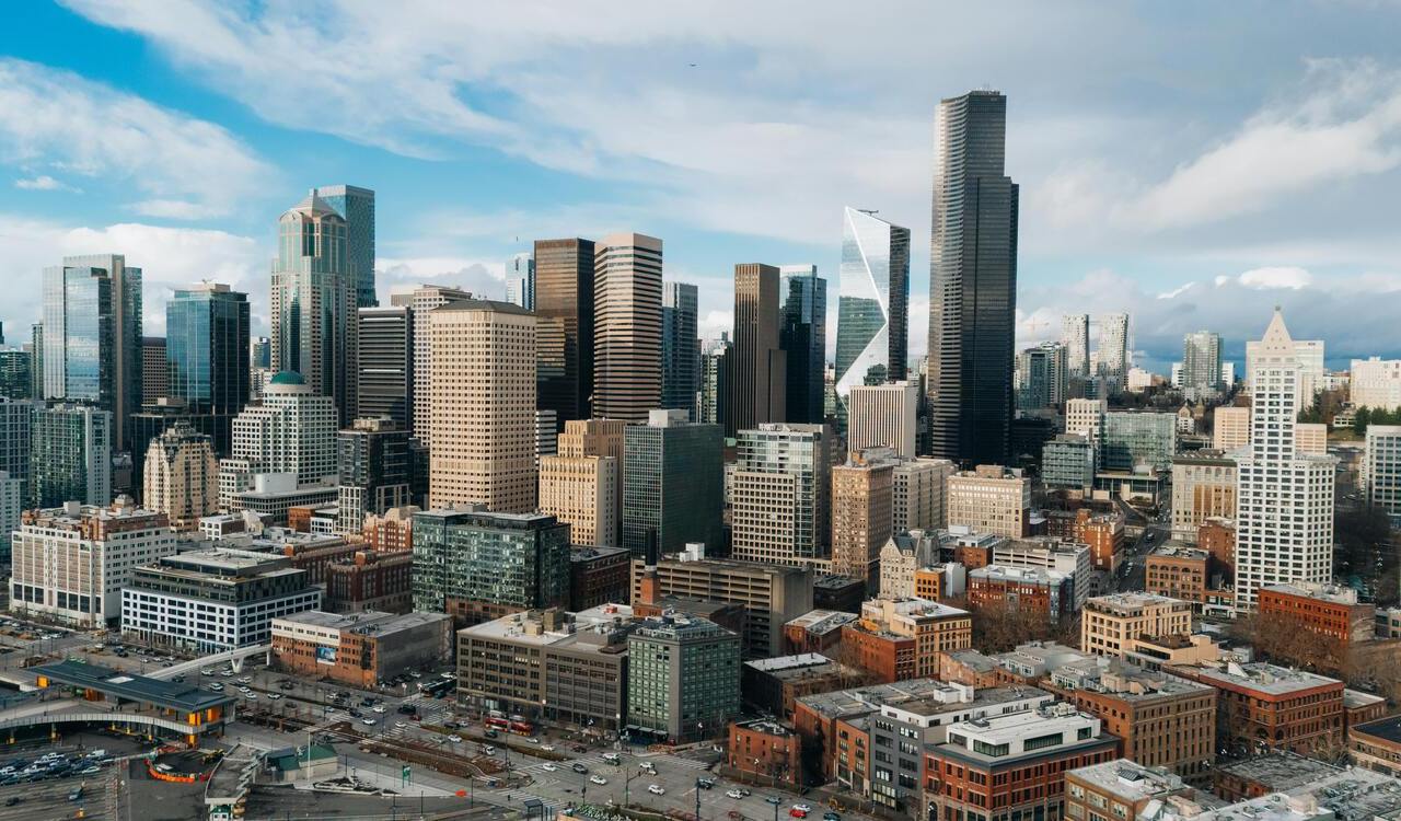 Seattle downtown skyline under partly cloudy skies.