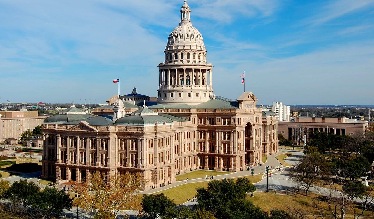 Texas State Capitol building in Austin under a clear blue sky