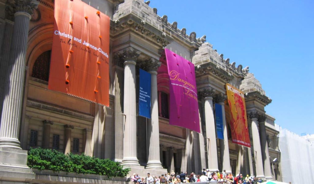 Metropolitan Museum of Art entrance with banners and visitors