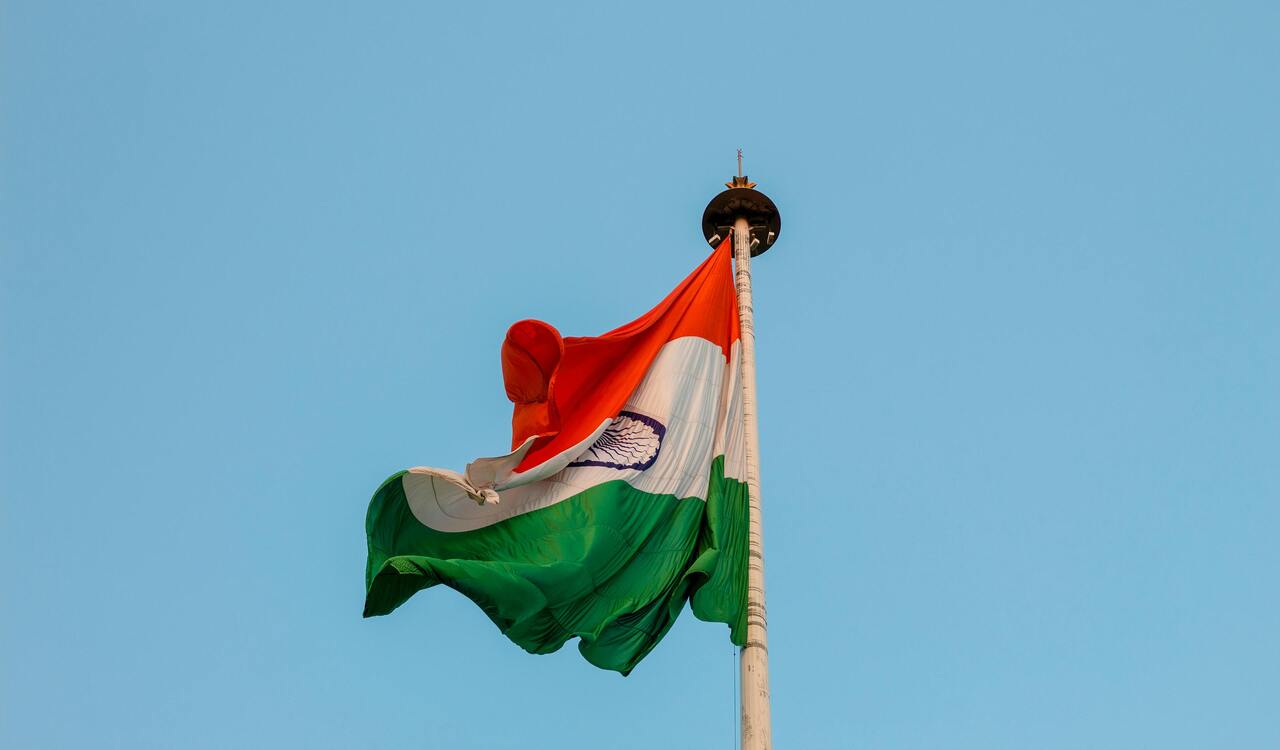 Photo of a Flag in a Pole Being Blown by Air