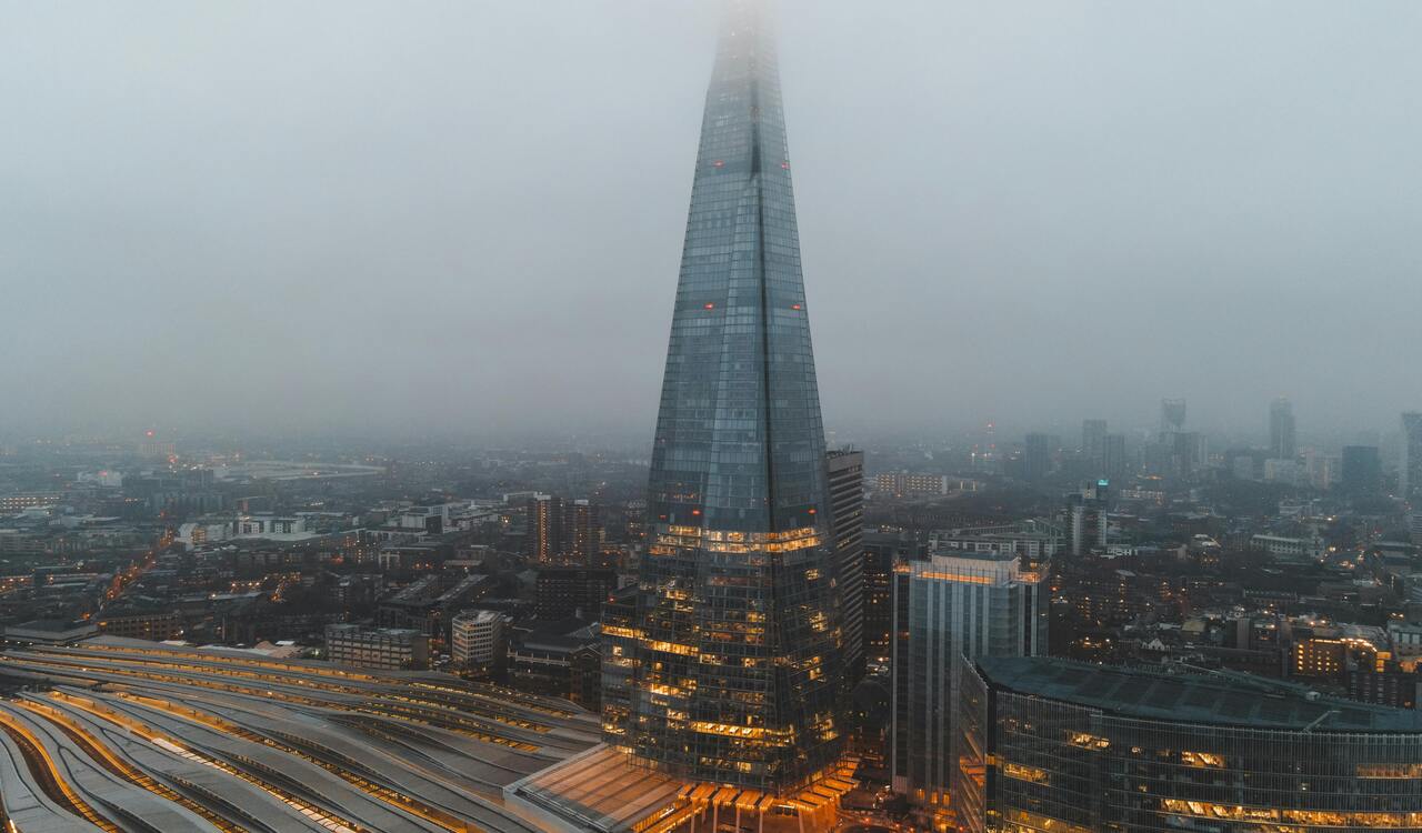 City with buildings and skyscraper with railways in misty day