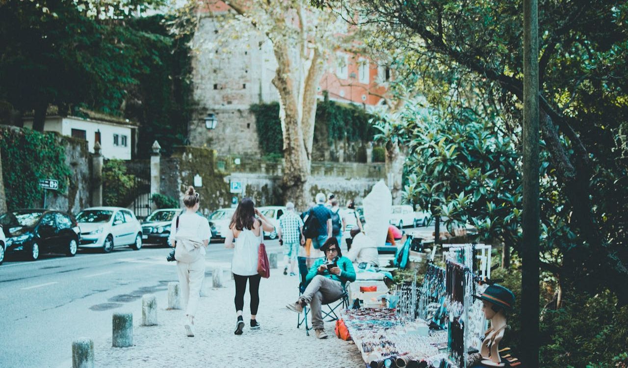People strolling past a vibrant street market in Budapest