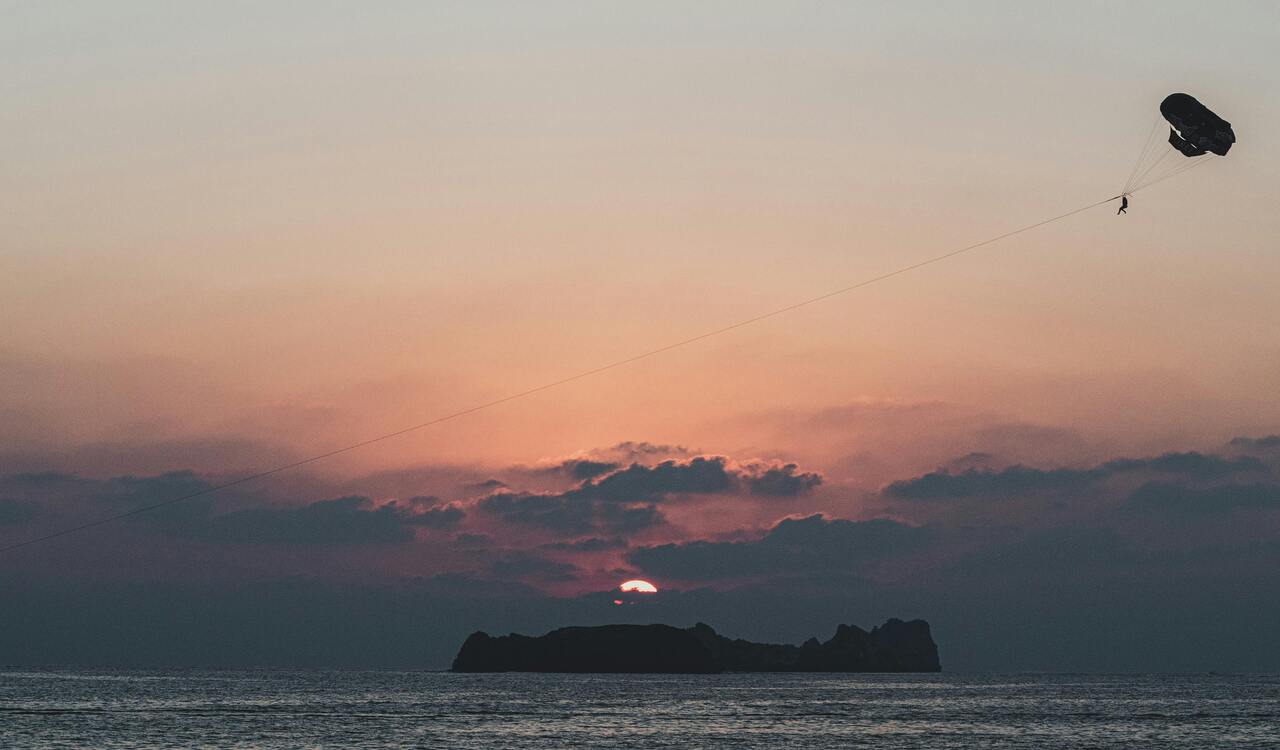 A Person Parachute Jumping at Sunset