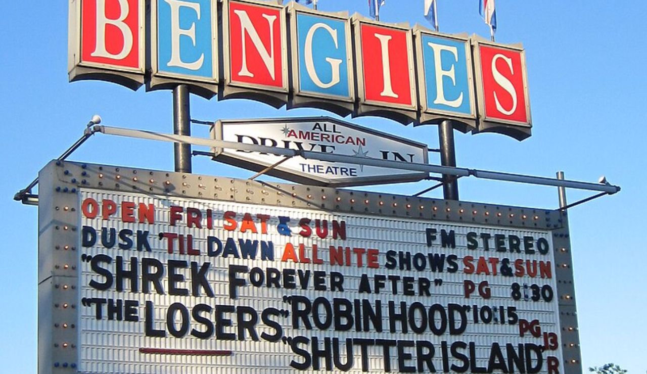 Vintage Bengies Drive-In Theatre marquee sign listing movies like Shrek Forever After, Robin Hood, and Shutter Island, with showtimes from dusk till dawn.