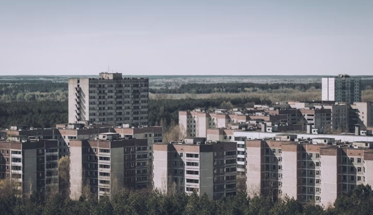 Abandoned Soviet-era apartment blocks surrounded by forest in Pripyat, Ukraine.