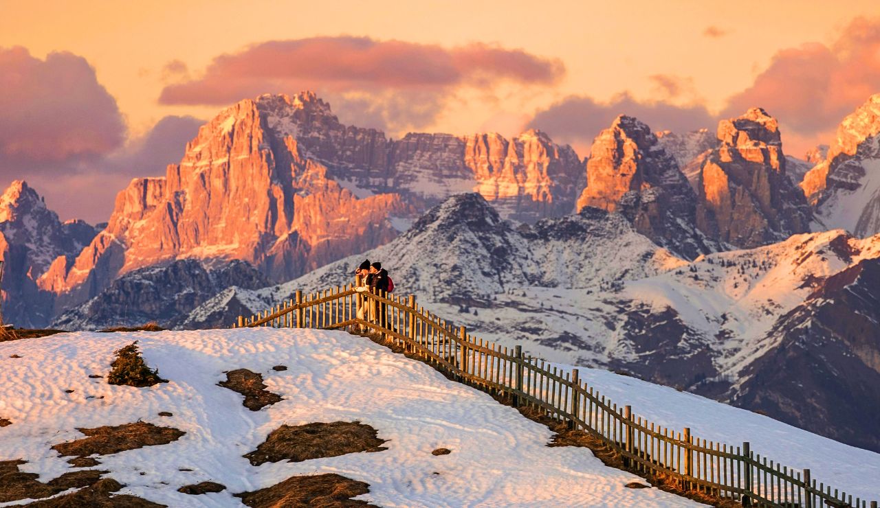 Steep Mediterranean hills with snow-covered cliffs along the coastline.