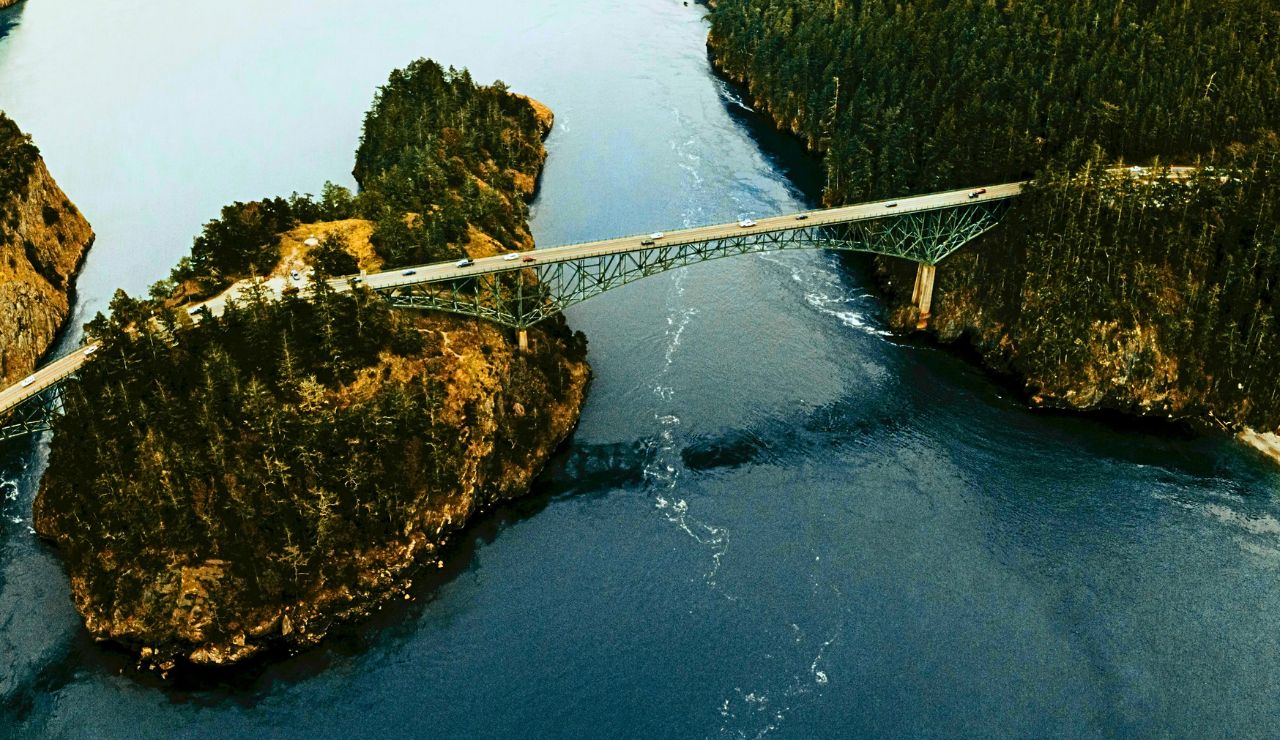 Deception Pass Bridge over emerald waters and rocky shoreline
