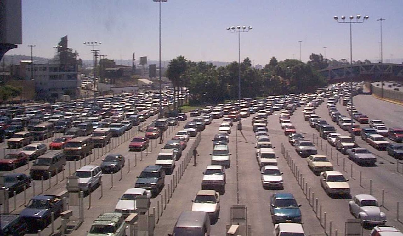 A massive traffic jam with hundreds of cars lined up across multiple lanes, stretching far into the distance.