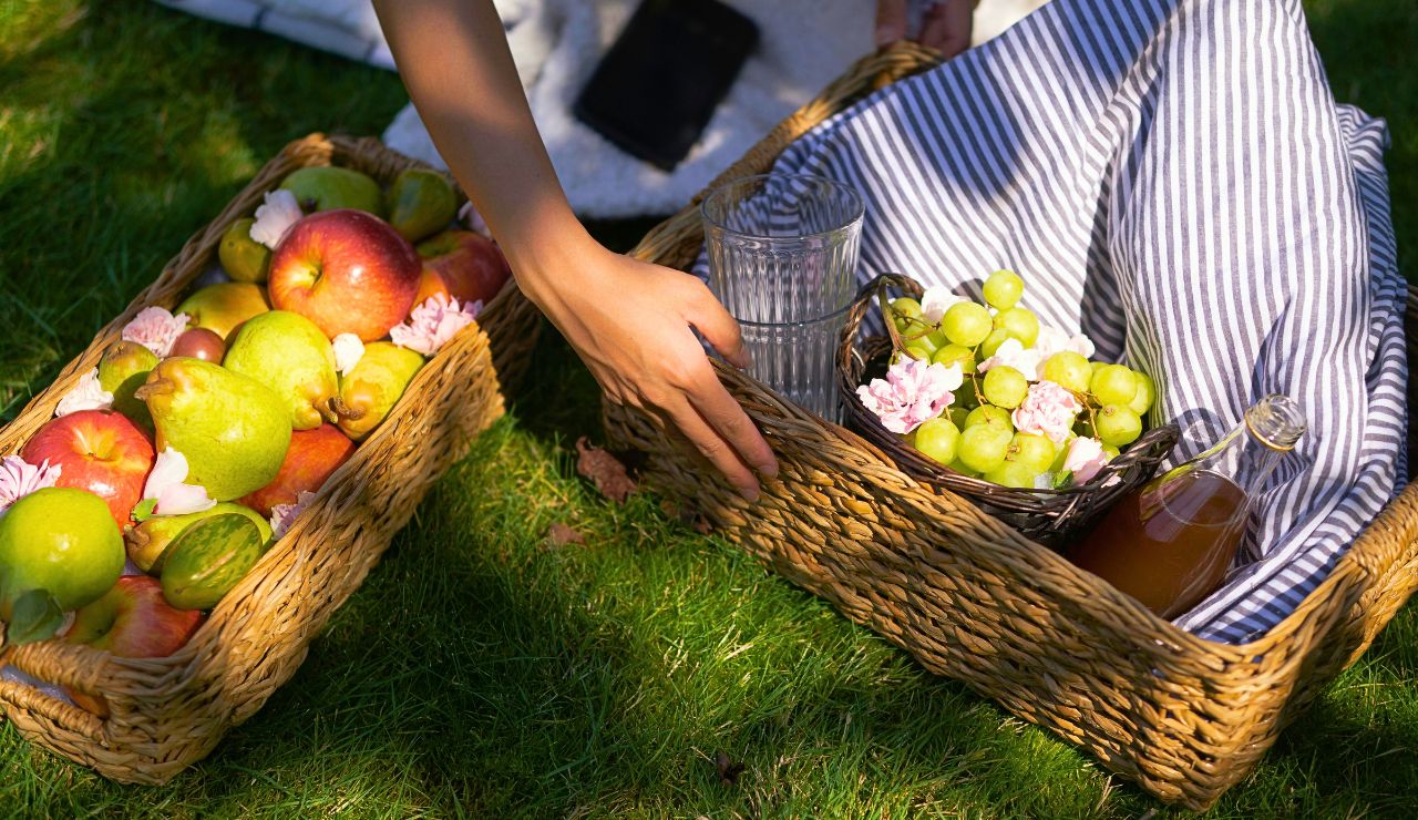 Sunlight hitting baskets of fruit and fresh flowers at dawn